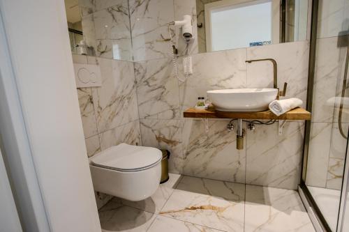 a bathroom with a toilet and a sink at Parklane Boutique Hotel - Newly Renovated in Vienna
