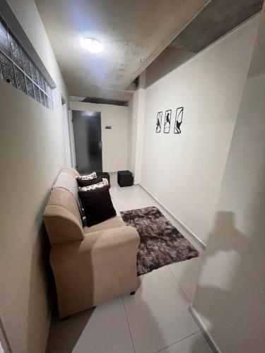 a living room with a couch and a rug at Apartamento centro garanhuns 3 quartos in Garanhuns