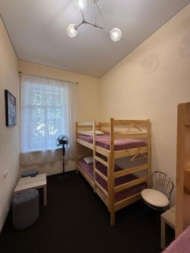a bedroom with two bunk beds and a window at Happy Home Hostel in Odesa