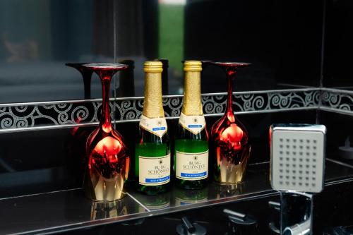 a group of four bottles of wine on a shelf at Villa Sweet Dreams in Novi Sad