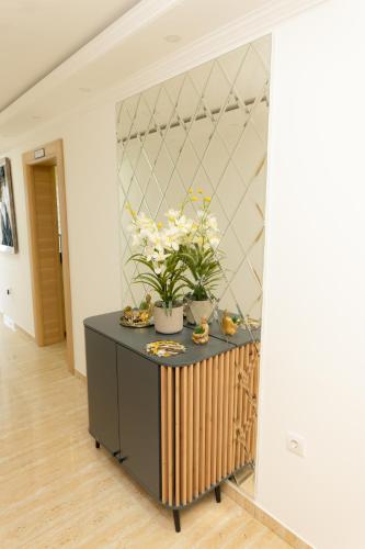 a room with a table with flowers on it at Villa Sweet Dreams in Novi Sad