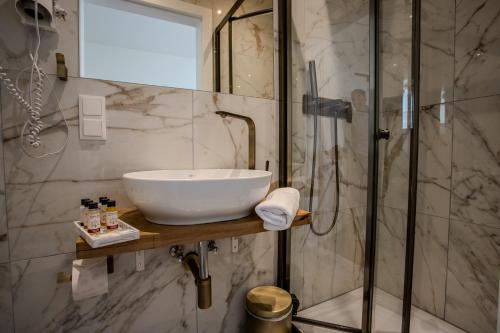 a bathroom with a sink and a shower at Parklane Boutique Hotel - Newly Renovated in Vienna