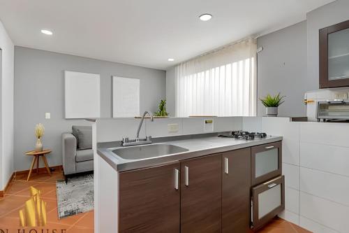 a kitchen with a sink and a counter top at Aria Living 500 - Modern with Private Terrace in Guayaquil