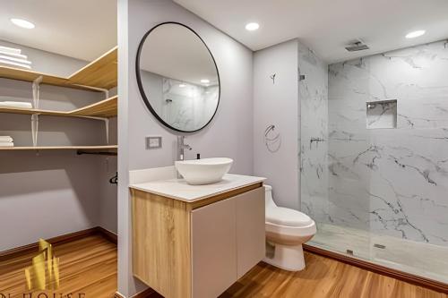 a bathroom with a sink and a mirror at Aria Living 502 - Luxury Terrace in Laureles in Guayaquil