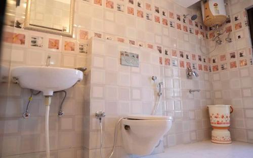 a bathroom with a sink and a toilet at Hotel SHIMLA REGENCY CHAKKAR in Shimla