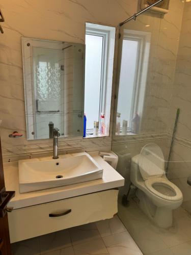 a bathroom with a sink and a toilet and a mirror at 1-Room Cozy Private Stay in Changla Gali in Abbottābād