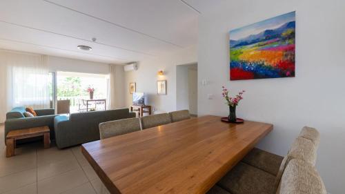 a living room with a table and a couch at Blue Bay Ocean Dreams Beachfront in Sint Michiel