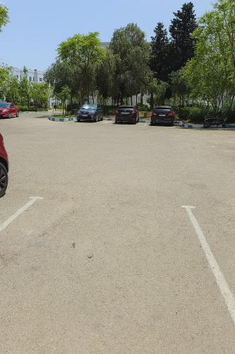 a parking lot with several cars parked in it at CHU -Family Apartment in Tangier in Daidatz