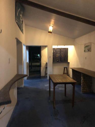 a living room with a table and a fireplace at Chalé frete lagoa in Caucaia