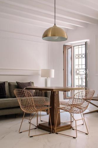 a living room with a table and chairs at Next Level Apartments in Villajoyosa