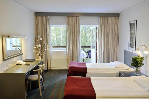 Postel nebo postele na pokoji v ubytování Ariston Hotell