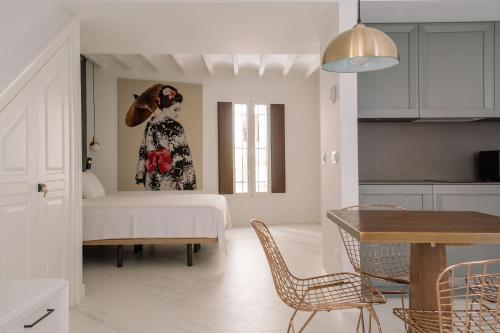 a living room with a bed and a painting of a woman at Next Level by Seaward Suites in Villajoyosa