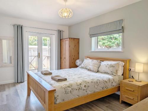 a bedroom with a bed and a window at Barn Cottage in Wick