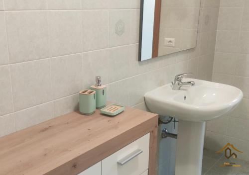 a bathroom with a sink and a mirror and a sink at Maia Etna Sea Guest House in Riposto
