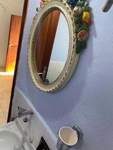 a mirror on a wall above a sink in a bathroom at Casa Lizluba in Montefegatesi