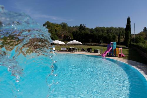 a swimming pool with a water slide and a playground at Villa Rosanna Siena Authentic Retreat in Siena