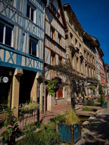 a group of buildings with plants in front of them at Chambres d'hôtes La Tribu in Quévreville-la-Poterie