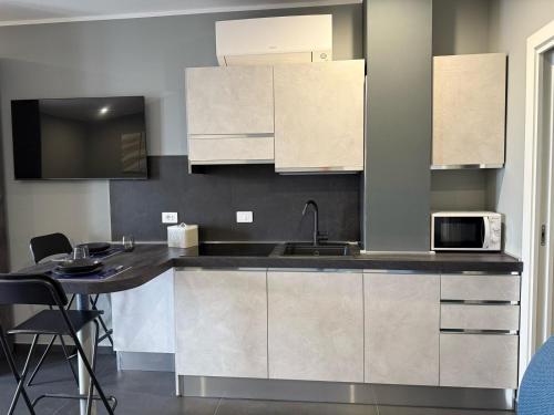 a kitchen with a sink and a microwave at ANGELICA Luxury in Bologna