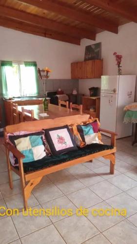 a wooden bench with pillows on it in a kitchen at Marcelo Buja in Jardín América