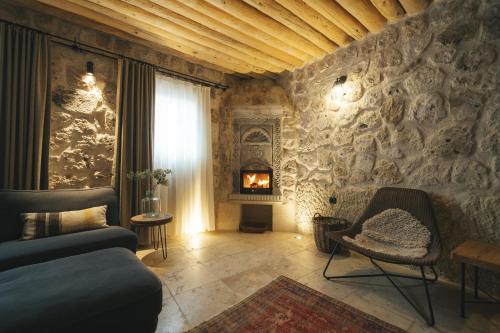 a living room with a couch and a fireplace at Vie Cappadocia - Adults Only in Nevsehir