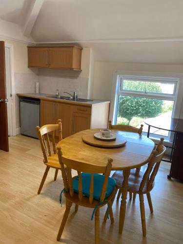 a kitchen and dining room with a wooden table and chairs at Superior, spacious apartment in New Brighton, near Liverpool in New Brighton