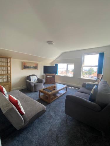 a living room with two couches and a coffee table at Superior, spacious apartment in New Brighton, near Liverpool in New Brighton