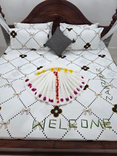 a white bed with some pillows on it at Kite Active Paje in Paje