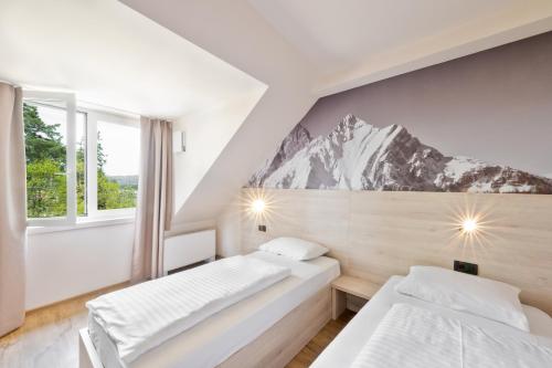 Postel nebo postele na pokoji v ubytování Hotel Arena Maribor