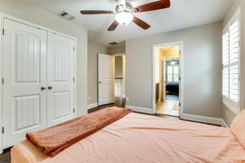 a bedroom with a bed and a ceiling fan at Group Getaway with Home Theater in San Antonio! in Helotes