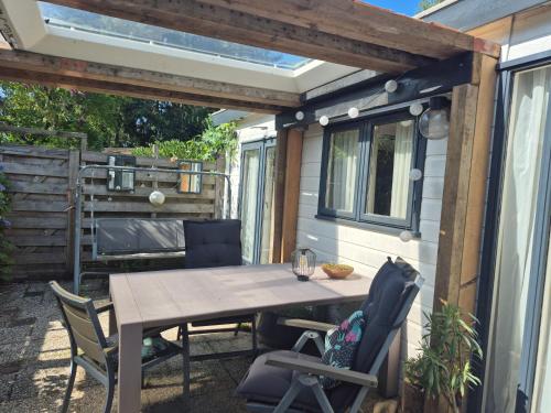 a table and chairs on the patio of a trailer at Chalet op de veluwe in Putten