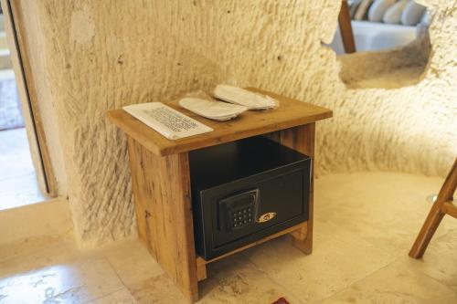 a wooden table with a stove in a room at Vie Cappadocia - Adults Only in Nevsehir