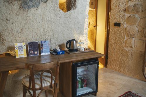 a wooden table with a stove in a room at Vie Cappadocia - Adults Only in Nevsehir