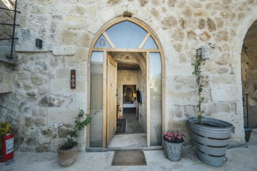 an entrance to a stone building with an arched doorway at Vie Cappadocia - Adults Only in Nevsehir