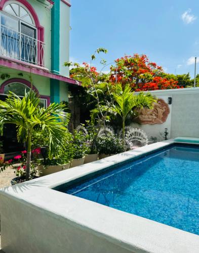 a swimming pool in front of a building at The Quetzal in Cancún