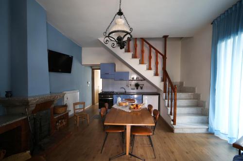 a dining room with a table and a staircase at La Casa Del Borgo in Brienza