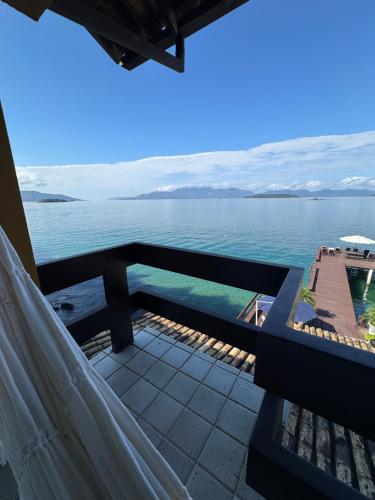a view of the ocean from the balcony of a house at Pousada Casa do Bicho Preguiça in Angra dos Reis