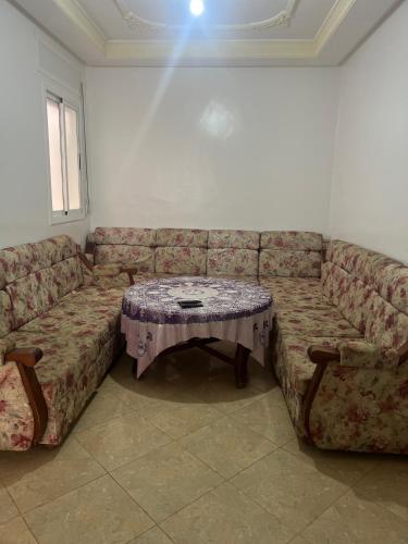 a living room with a couch with a table at Irmis in Oued Laou