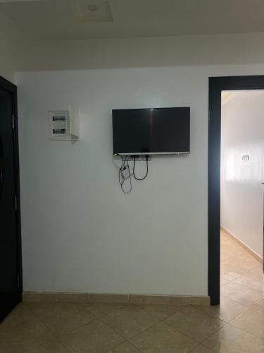 a wall with a flat screen tv on a white wall at Irmis in Oued Laou