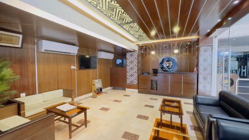 a living room with a couch and a table at Hotel The Grand Hyatt Dhaka in Dhaka