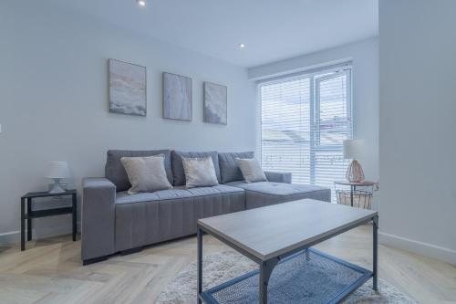 a living room with a couch and a table at Unit 3 Sleek 1-BR Stays, Near Sheffield United Football Club, Fast Wi-Fi, Parking in Sheffield