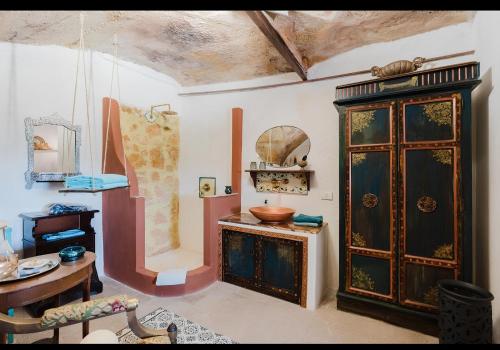 a living room with a wooden cabinet and a table at Casa d'Artista con Terrazza Panoramica nel Borgo" Ajman house in Sambuca di Sicilia