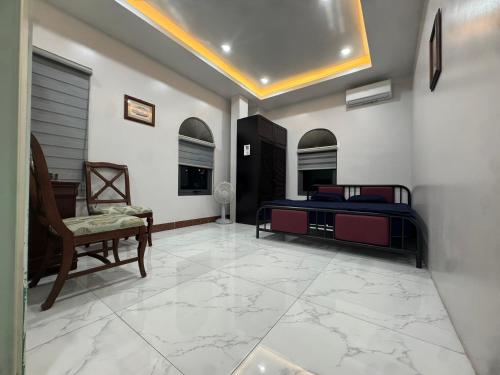 a bedroom with a bed and a chair at Linh San Hotel in Thinh Làng