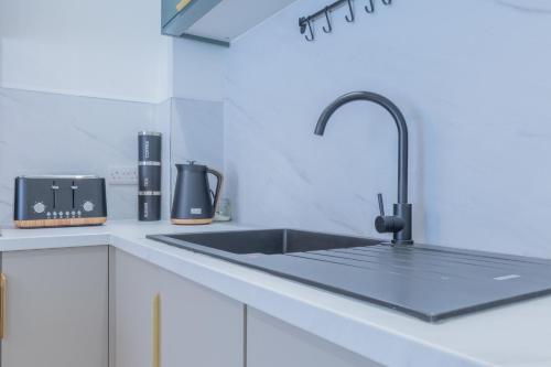 a kitchen with a sink and aaucet at Unit 3 Sleek 1-BR Stays, Near Sheffield United Football Club, Fast Wi-Fi, Parking in Sheffield