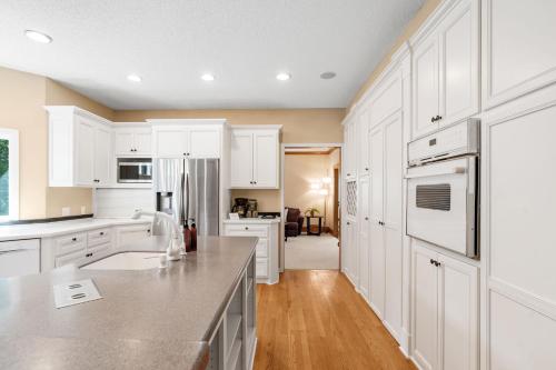 a kitchen with white cabinets and a counter top at Serenity on the Creek in Eden Prairie