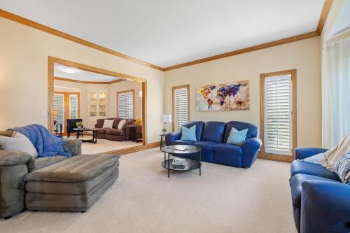 a living room with blue furniture and a mirror at Serenity on the Creek in Eden Prairie