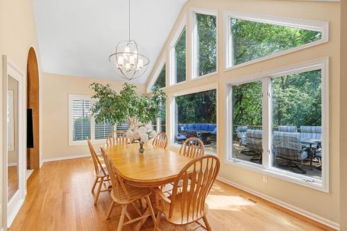 a dining room with a wooden table and chairs at Serenity on the Creek in Eden Prairie