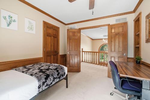 a bedroom with a desk and a bed and a table at Serenity on the Creek in Eden Prairie
