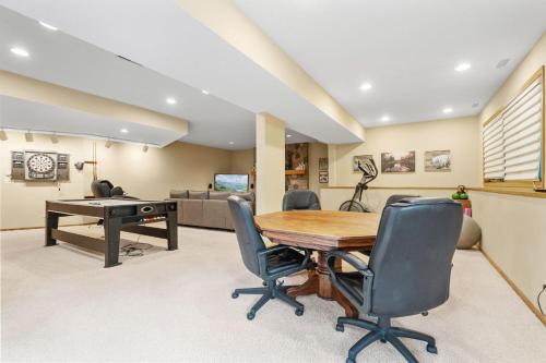 an office with a wooden table and chairs at Serenity on the Creek in Eden Prairie