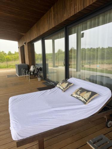 a large bed in a room with large windows at Harmony Resort & Spa in Padumble