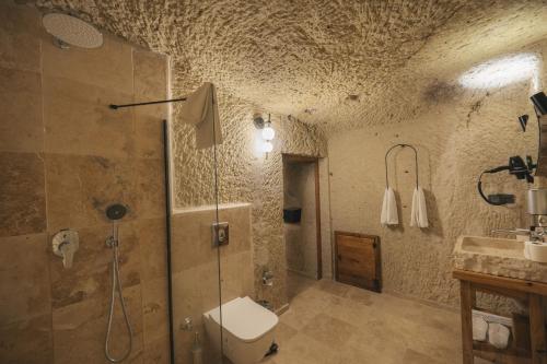 a bathroom with a shower and a toilet and a sink at Vie Cappadocia - Adults Only in Nevsehir